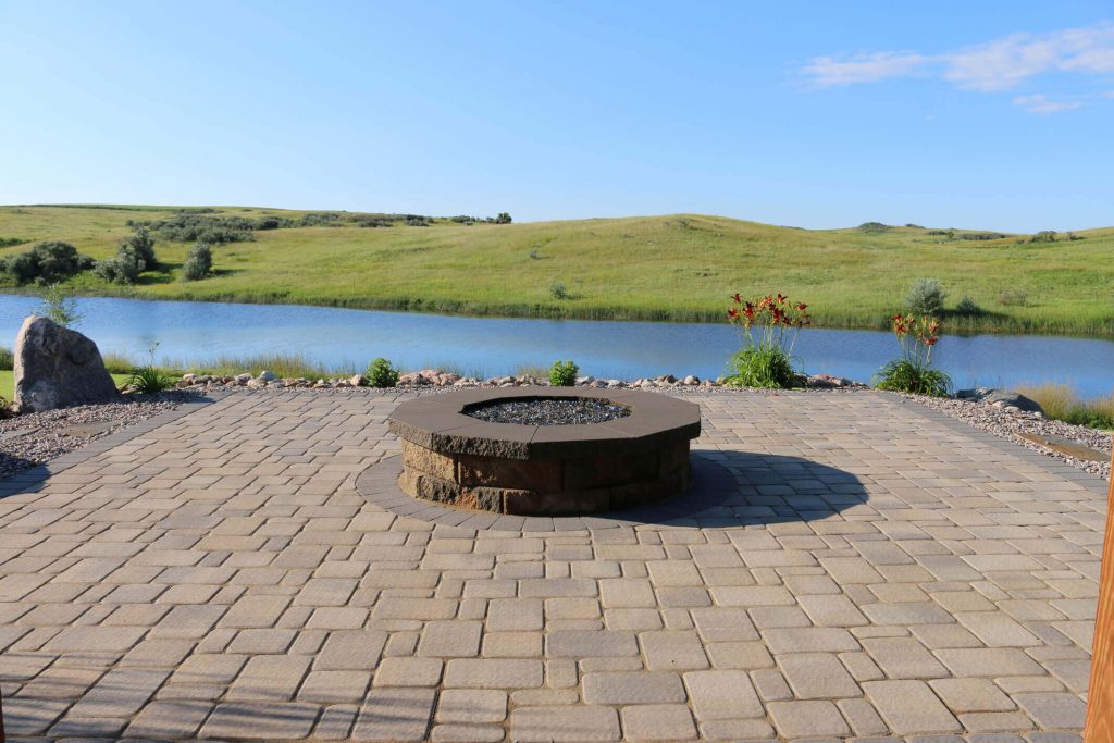 stone fire pit on stone paver patio with a view